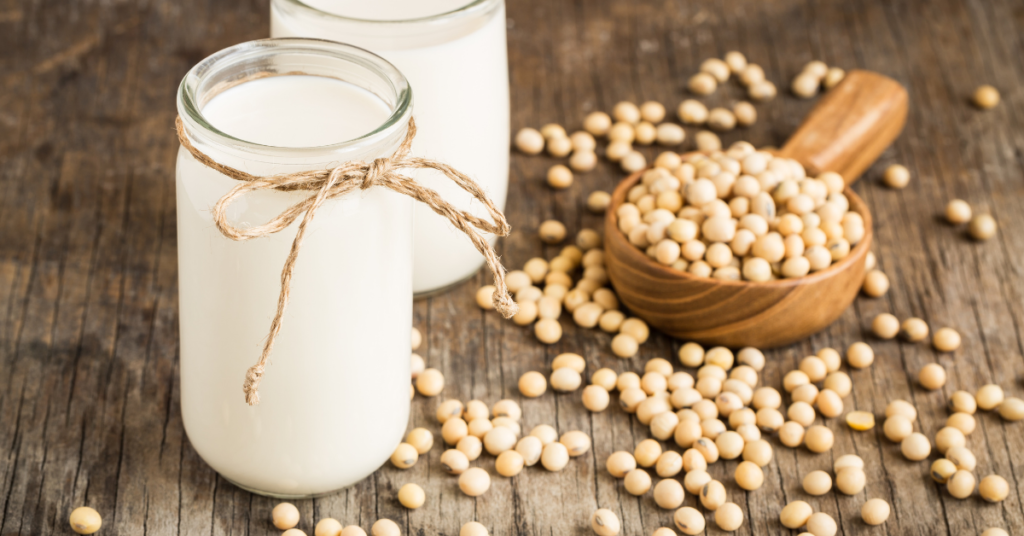 Soymilk with soybeans on table